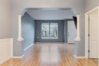 Building Photo - Lovely and bright townhouse with a hard wood flooring throughout, a 2 car garage, AC & more!