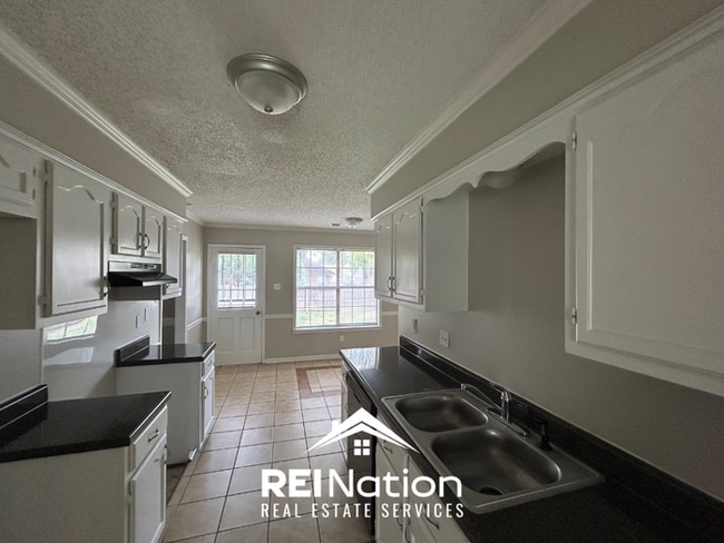 Building Photo - Spacious 4BR/2BA Near Southwind | High Ceilings, Brick Fireplace & 2-Car Garage