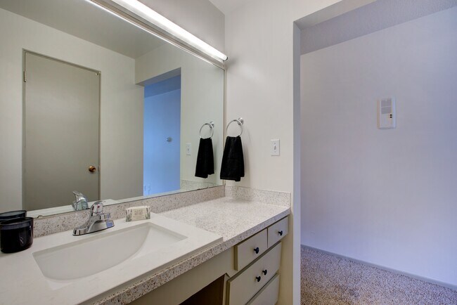 Experience modern elegance in this beautifully designed bathroom. - Harmony Apartments