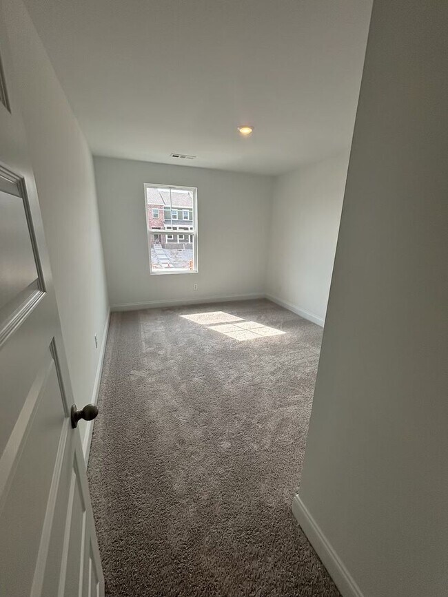 Building Photo - **BE THE LUCKY ONE TO LIVE IN THIS 2024-BUILT END-UNIT TOWNHOME IN A RESORT-STYLE COMMUNITY**