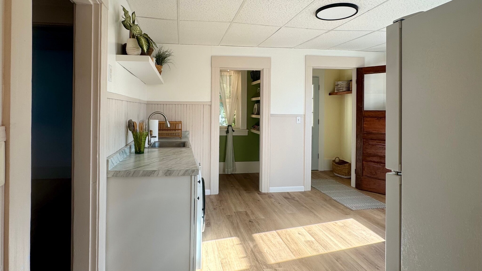 A view through the kitchen towards the backdoor and pantry. - 98 Maple St