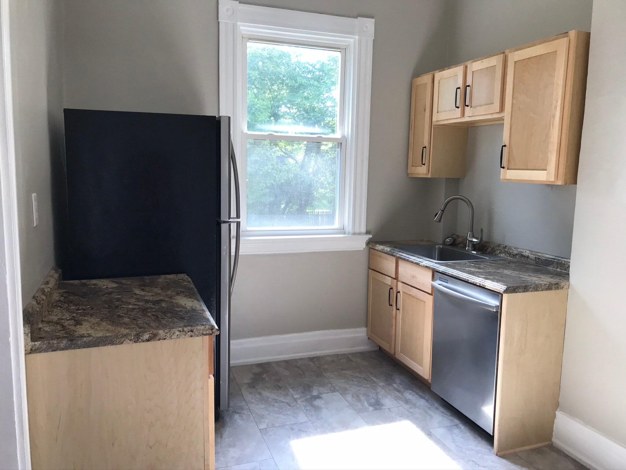 Kitchen with new cabinets and stainless appliances. Include fridge with ice maker, dishwasher and gas stove (coming soon). - 2221 Oakland Ave