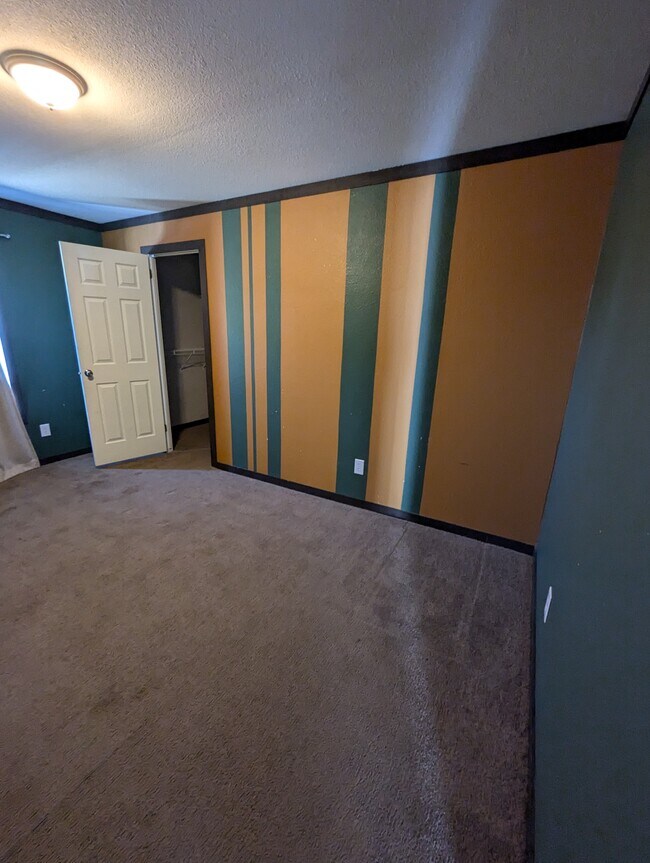 Room 3 looking at back of house and closet door - 179 Davis Rd
