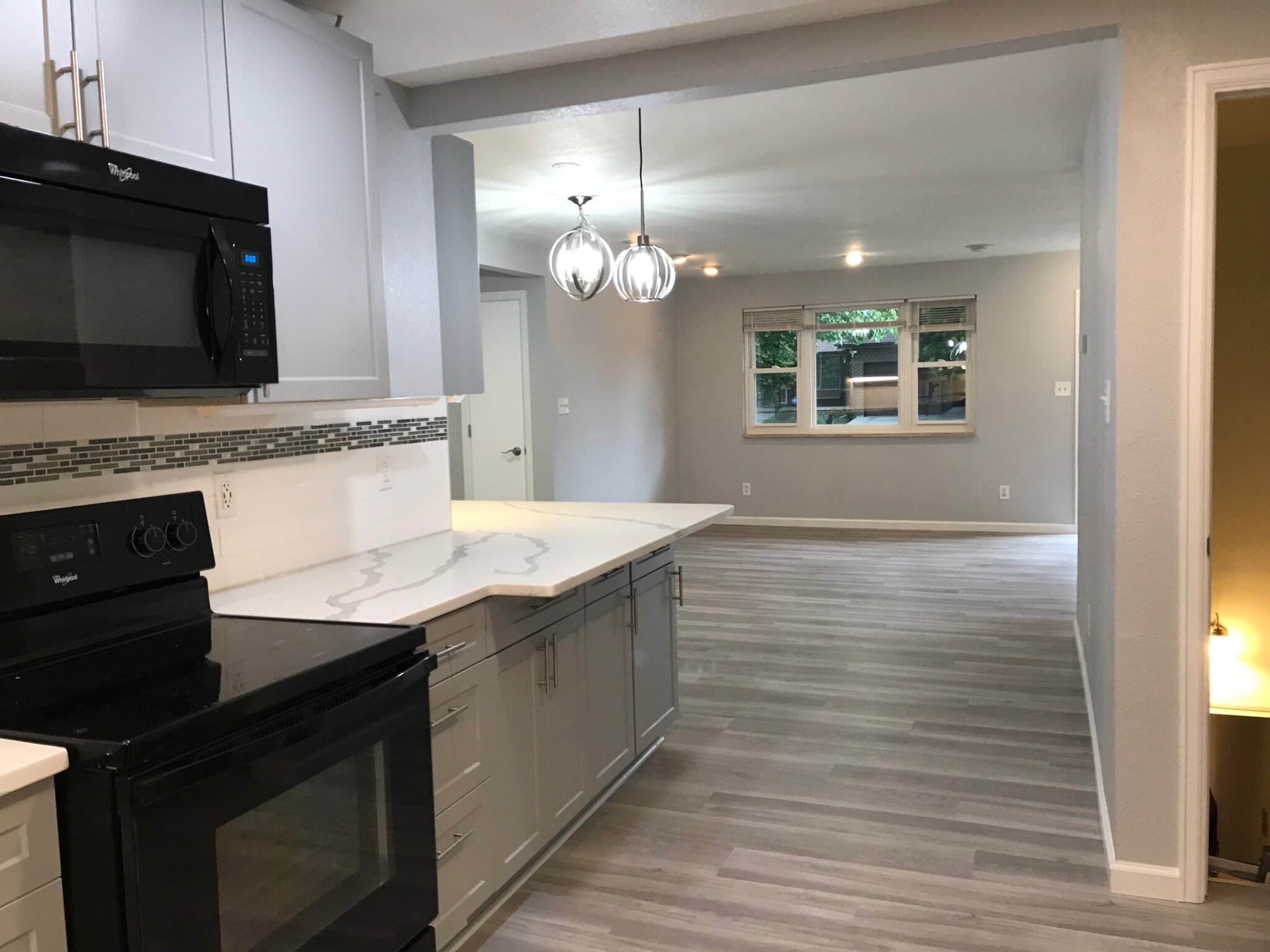 Spacious living room with new LVP flooring - 1180 S Depew St