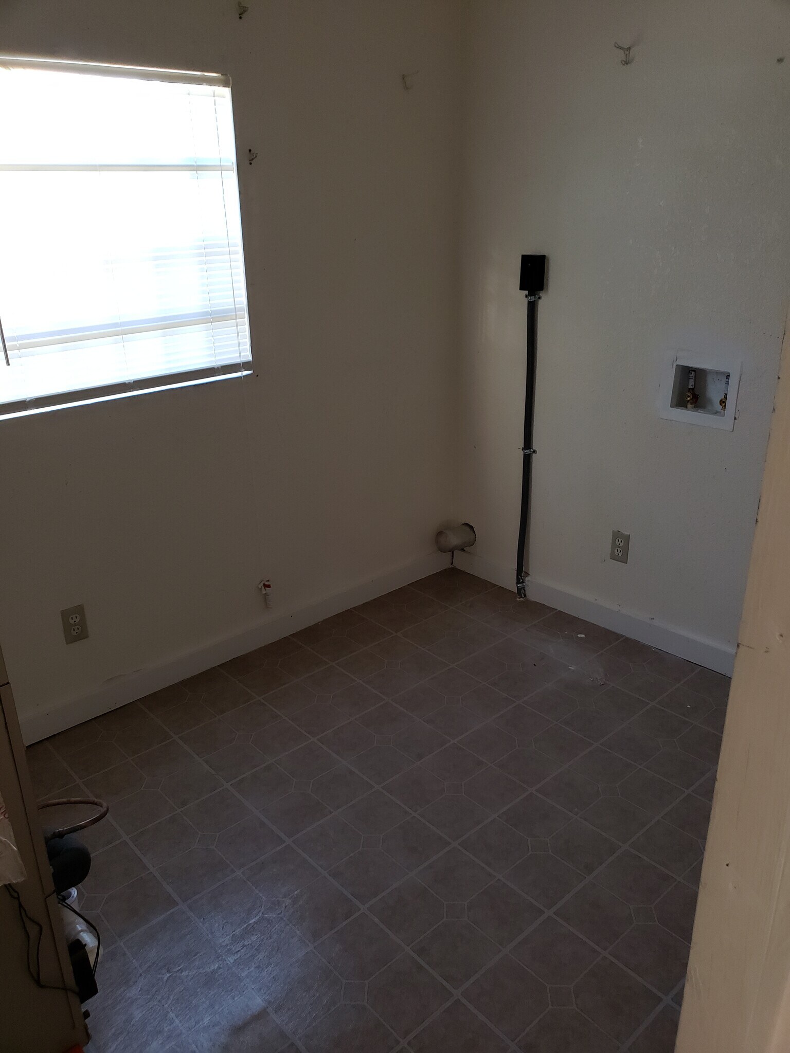 Utility room, has washer/dryer hook up and air handler for central heating and air. - 1717 W. 20th St. Apt. 1