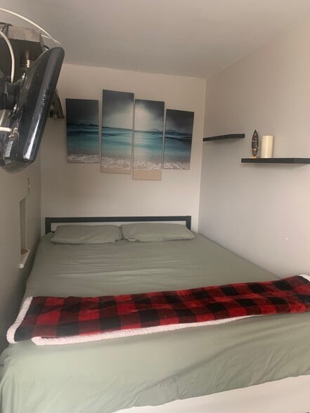 Queen bed, separated by dividing wall from living room - 2939 Van Ness St NW