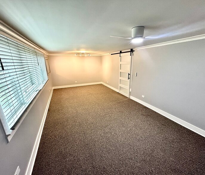 Large living room w/ barn door, crown molding, new large baseboards, all new lighting, 1.5” blinds. - 16W671 56th St
