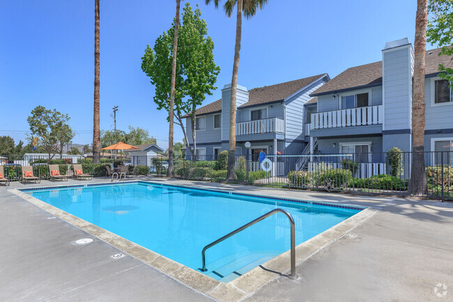 Image of the community swimming pool and welcoming lounge chairs in the background. - Camden Park