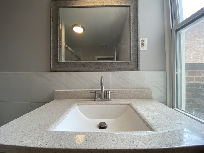 Modern spacious full bath, large shower, porcelain tile floor, granite countertop - 1618 Fitzwater St