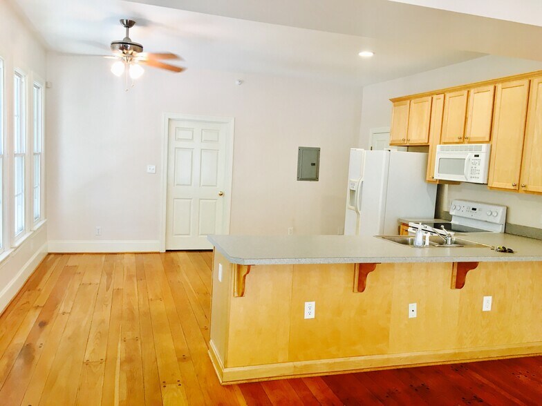 Kitchen with modern appliances, natural light, and open flow to dining and living. - 1937 Fairfield Dr