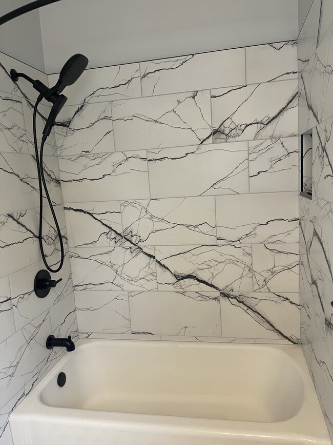 new bath tile and new black fixtures - 541 Lamar Ave