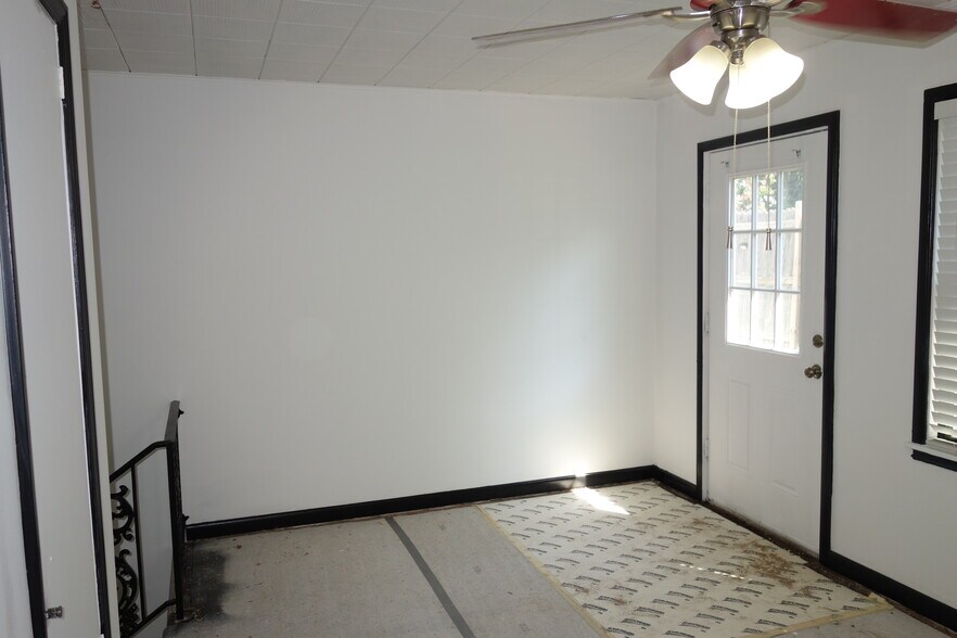Secondary bedroom with door to the petite backyard - 1745 S Birmingham Ave
