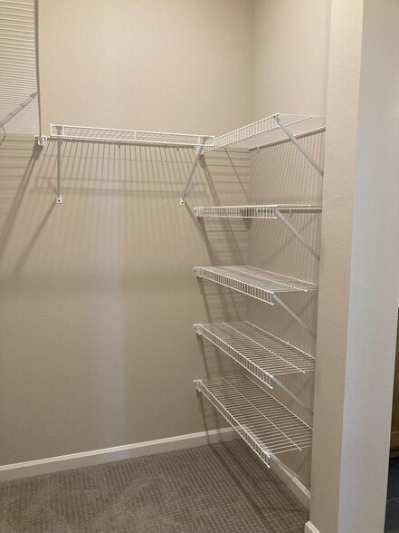 Large walk-in closet attached to master bath with build in shelves - 7471 SE Kinnaman St