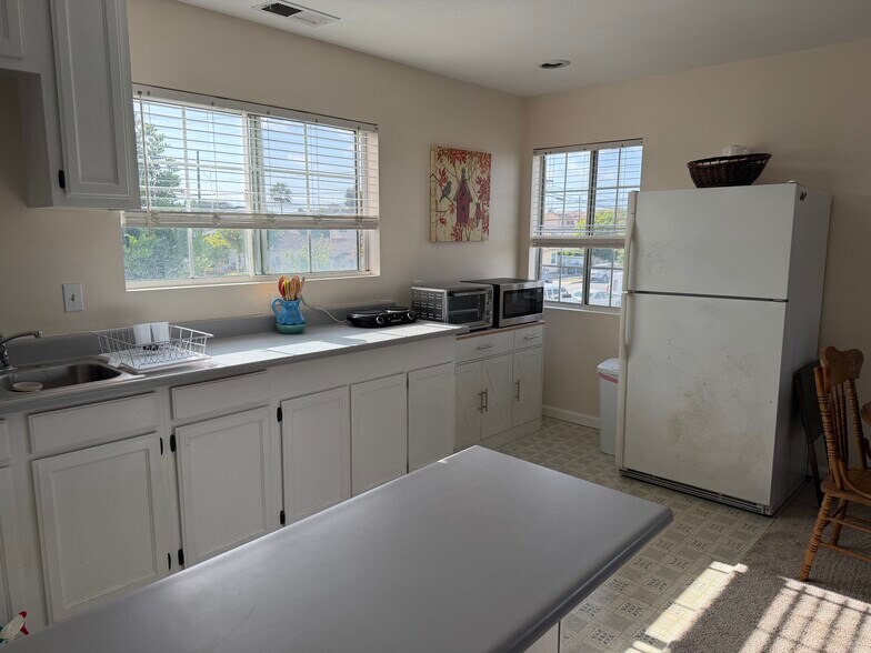 Kitchenette and full sized fridge - 14902 Eastwood Ave