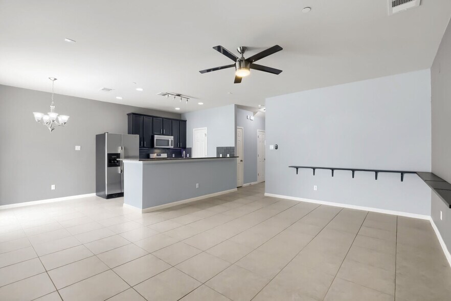 Living room features a wall mounted display ledge for behind the sofa - 1900 Little Elm Trl