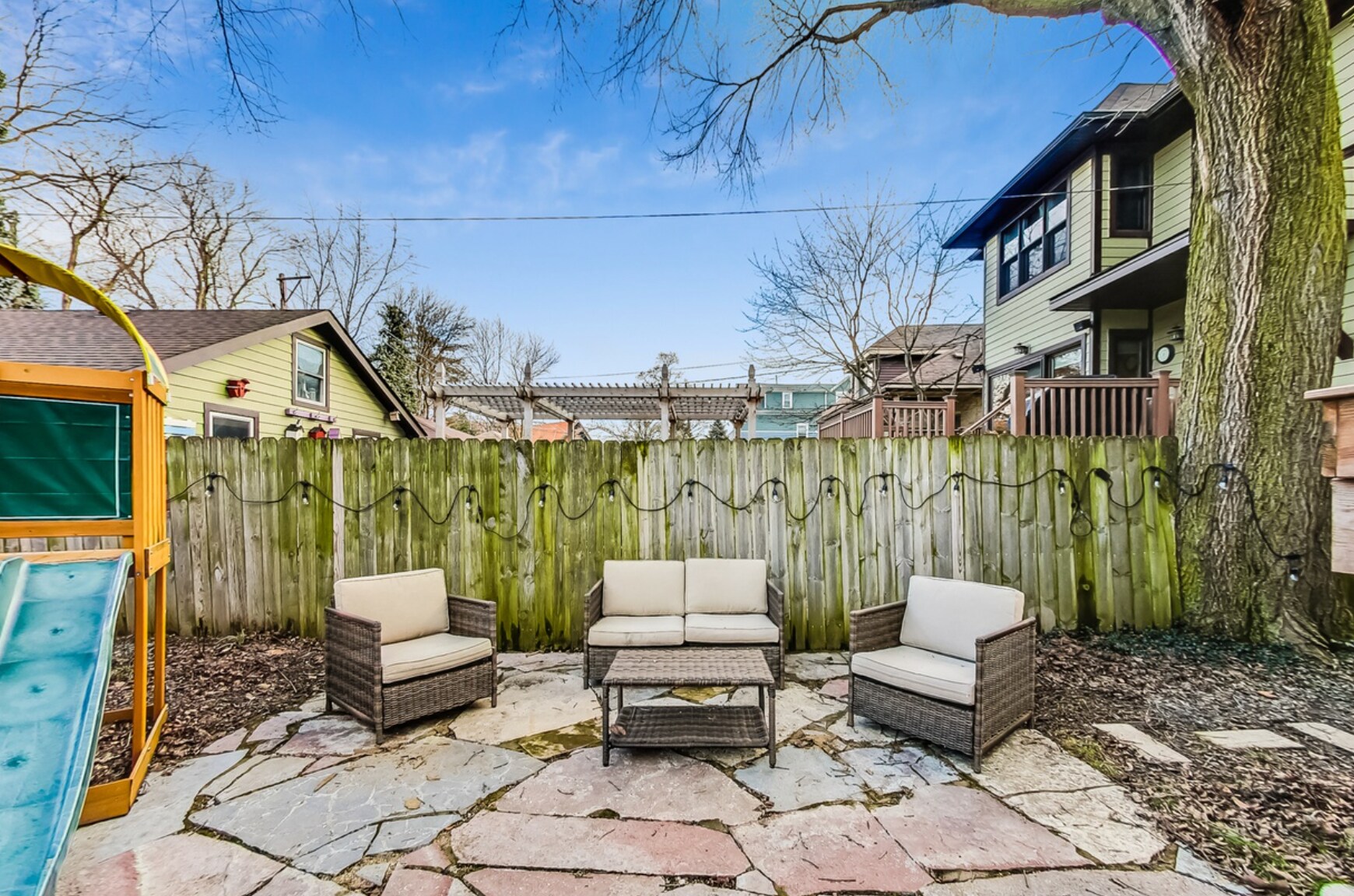 Backyard patio, firepit, and swing set for tenants' use - 3747 N Kostner Ave