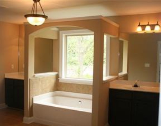 Oversized Master Bathroom with large tub separating his and her sinks. - 319 Haywood Dr