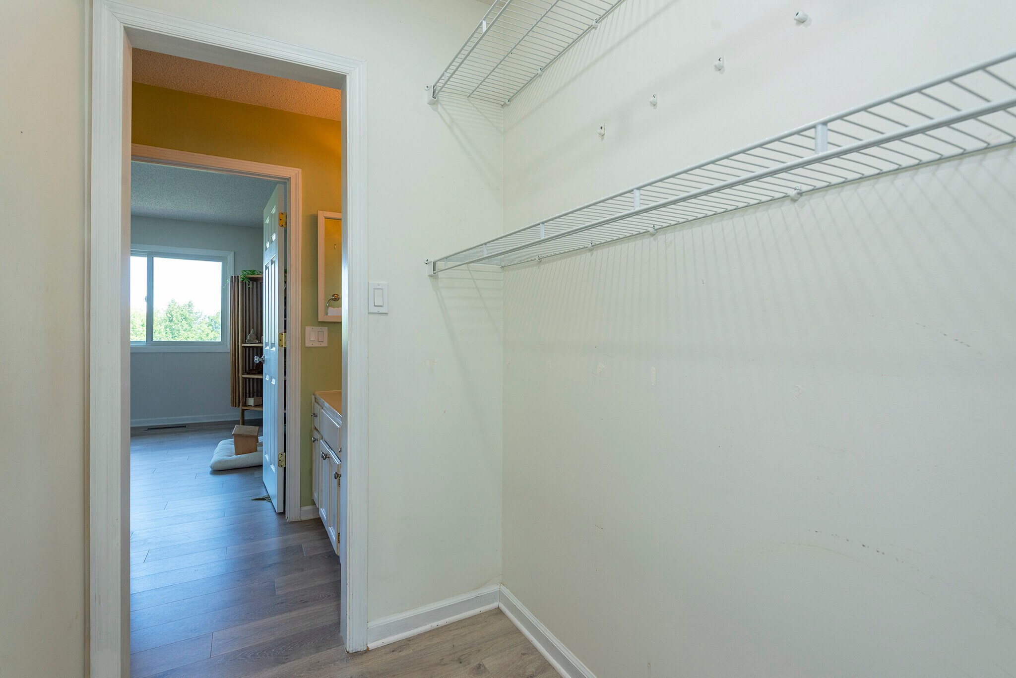 Spacious walk-in main floor closet with shelving - plenty of storage for your mountain lifestyle. - 405 Windswept Dr