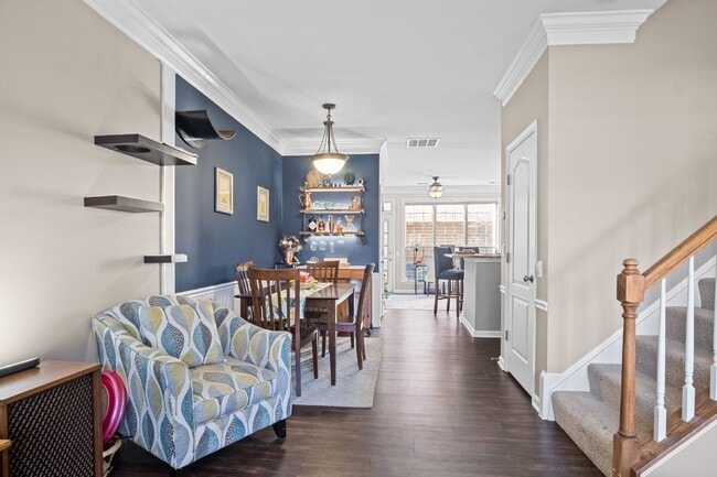 Building Photo - This inviting two-level townhome offers comfort and style, featuring gleaming hardwood floors on ...