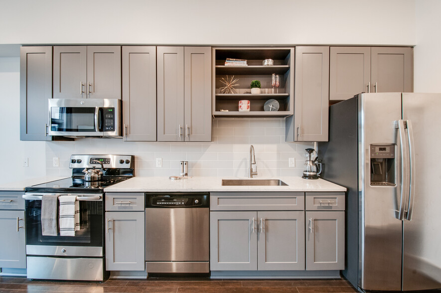 Chic gray cabinets, flattop range, microwave, dishwasher, disposal, sink spray & built-in shelves. - 2407 8th Ave S