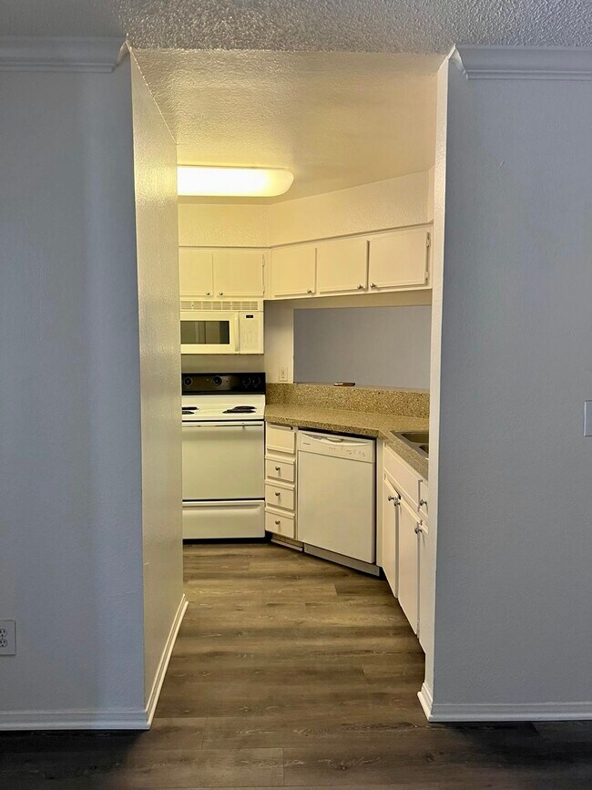Kitchen with new flooring and quartz countertops - 10655 Lemon Ave