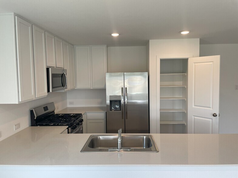 Kitchen with quartz counter tops - 25665 Rose Creek Dr