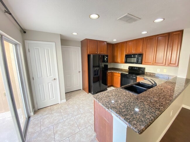 Building Photo - Avalon Park corner end Townhome featuring 3 bedrooms, 2.5 baths, plus office, and 2 car garage.