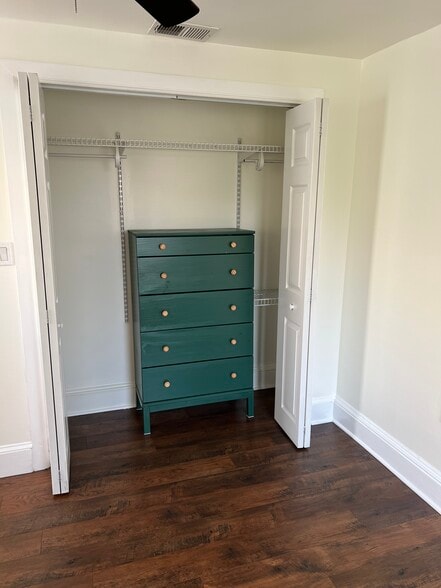 The master bedroom closet features a built-in dresser, along with space for hanging clothes. - 126 Merion Ave