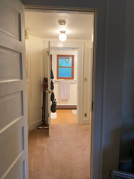 Hallway off living space, leads to bathroom, with storage closets in hallway- all newly painted - 340 NE Beyrl Ter