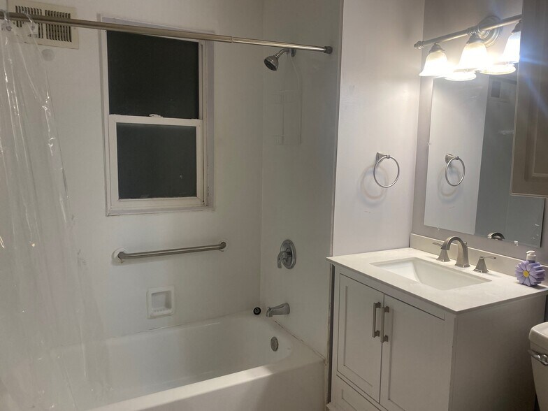 bath with newer vanity and tile floor - 717 N Highland Ave