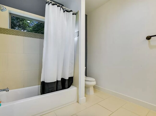 Upstairs bathroom with tub and shower - 2203 E 14th St