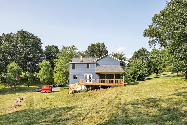 The oversized back deck provides both shade and sunshine as your enjoy the spacious back yard. - 2416 Magee Road Ext