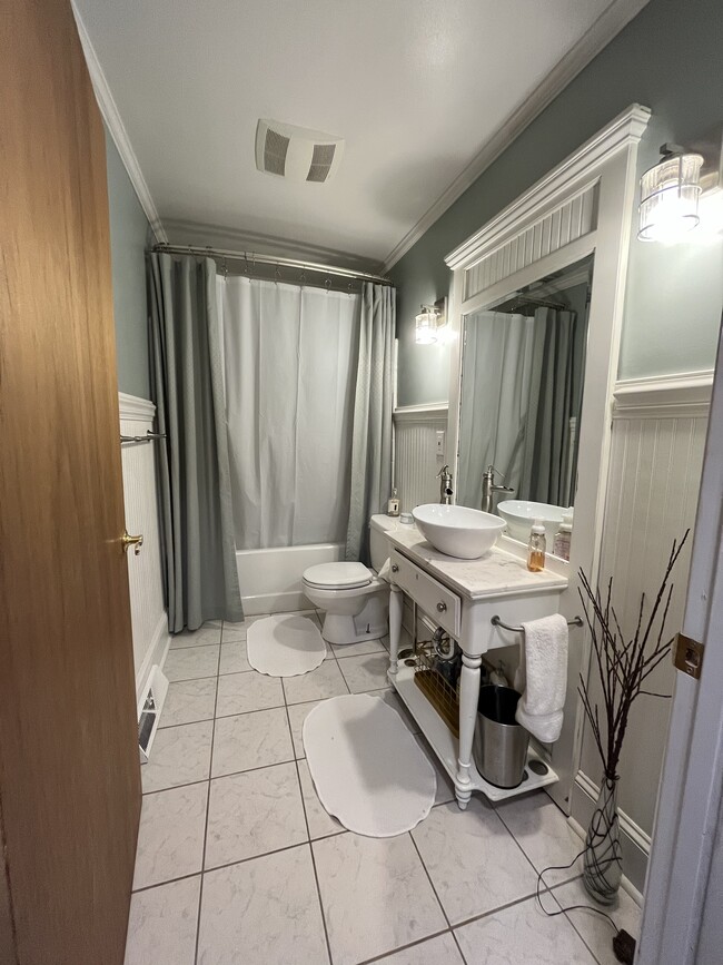 Guest bathroom refreshed in 2017. Tile floors and custom antique vanity - 2339 Kilborne Dr