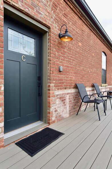 Private entryway with a patio area - 101 W Broadway St