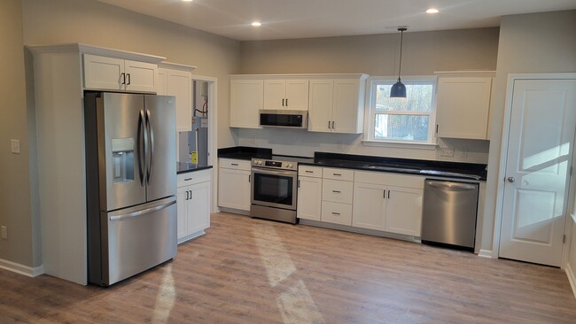 Kitchen area open to living room with pantry cliset - 203 Payne St