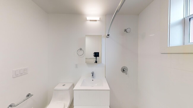 Bathroom with a toilet, sink and walk-in shower - 2500 Durant