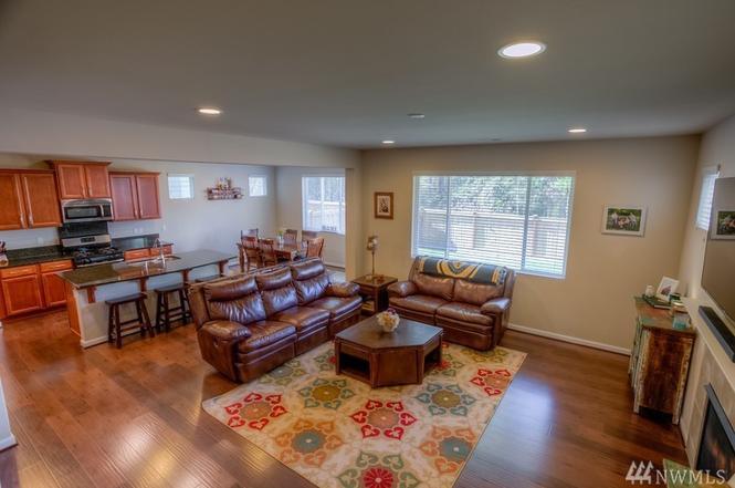 Family room, opens up to kitchen. And fully fenced backyard, with covered patio. - 8828 Jayden Ln NE