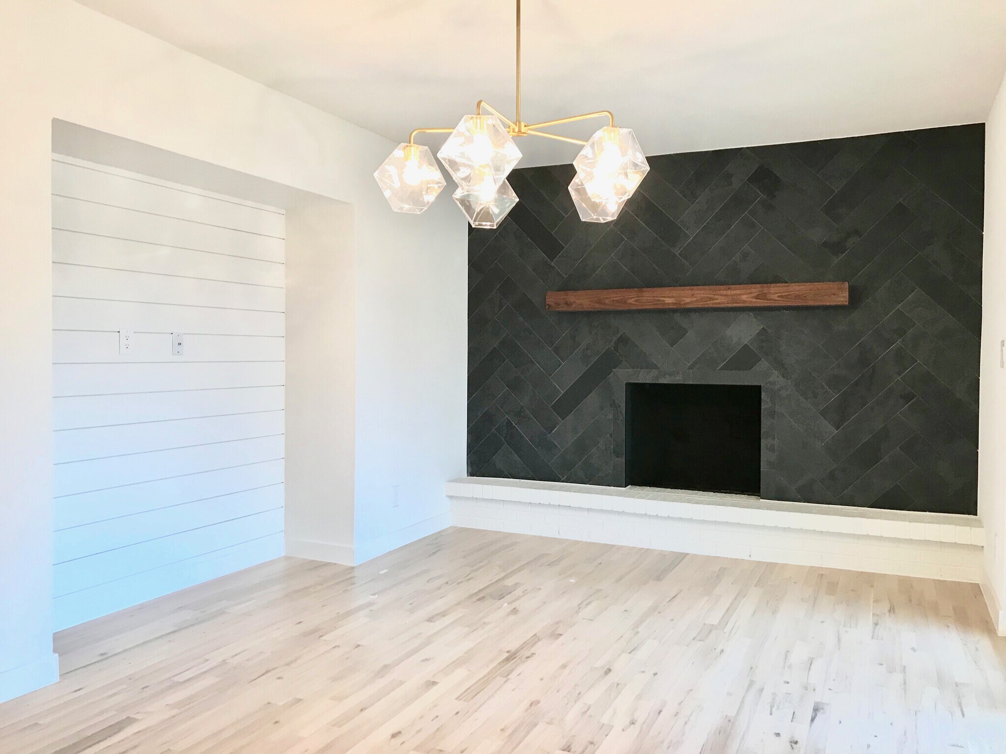 Dining Room with Herringbone Tiled Fireplace, Custom Walnut Mantle, West Elm Brushed Gold and Crafted Glass Chandelier - 3360 ward road