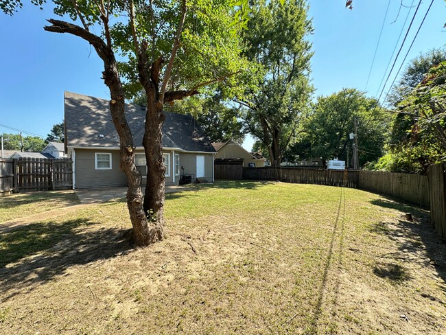 Building Photo - Charming 3BR/2BA Near Southwind | Hardwood Floors, Brick Fireplace, Bay Window & 2-Car Garage