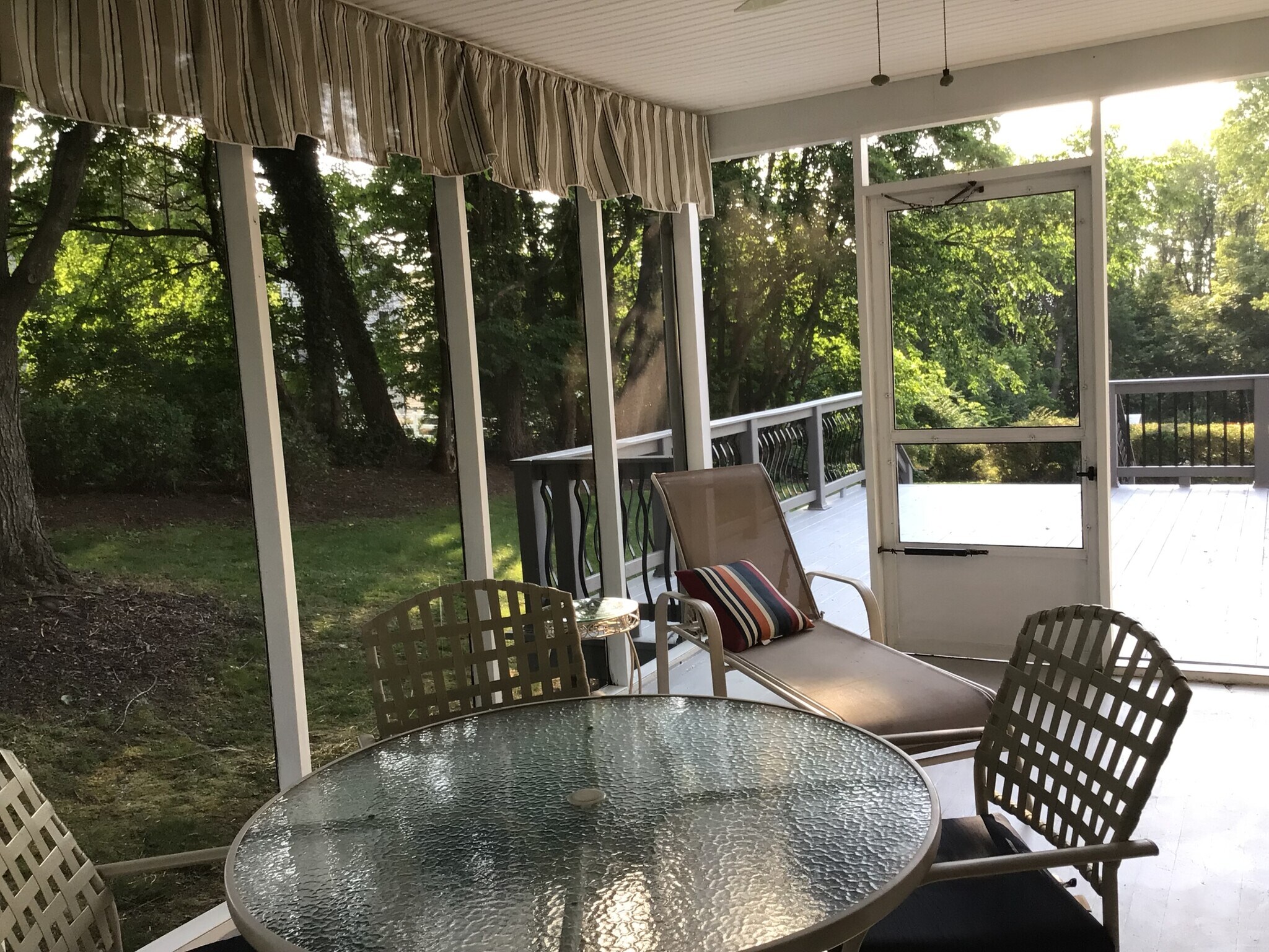 Newly painted floor in sunroom leading to newly painted deck. Furniture included. - 7288 Beechtree Ln