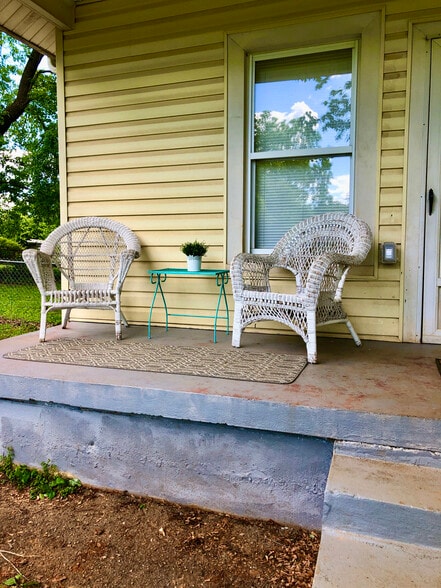Covered back porch leading to large flat fenced back yard with brand new garden shed. - 2205 Mayflower Dr