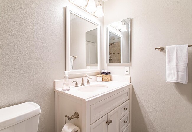 Bathroom featuring a cabinet-style vanity and fresh towels and toiletries. You have everything you n - 24137 Del Monte Dr