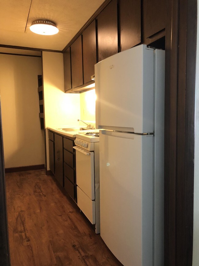 Galley kitchen with pantry - Pinewood Court Apartments