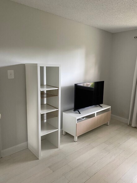 SmartTV, TV stand, and shelves. - 7922 Fitzroy St