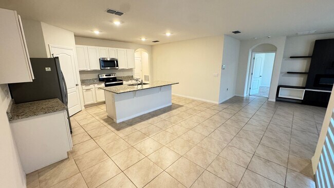 Building Photo - Available NOW! Spacious 4BD/2BA Haven in Villages at Harmony – Your Dream Home Awaits! WASHER & D...