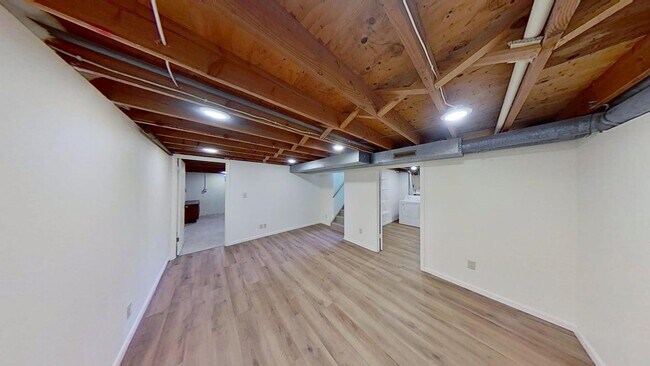 Building Photo - Updated two bedroom duplex, new stainless steel appliances, garage, and hardwood floors