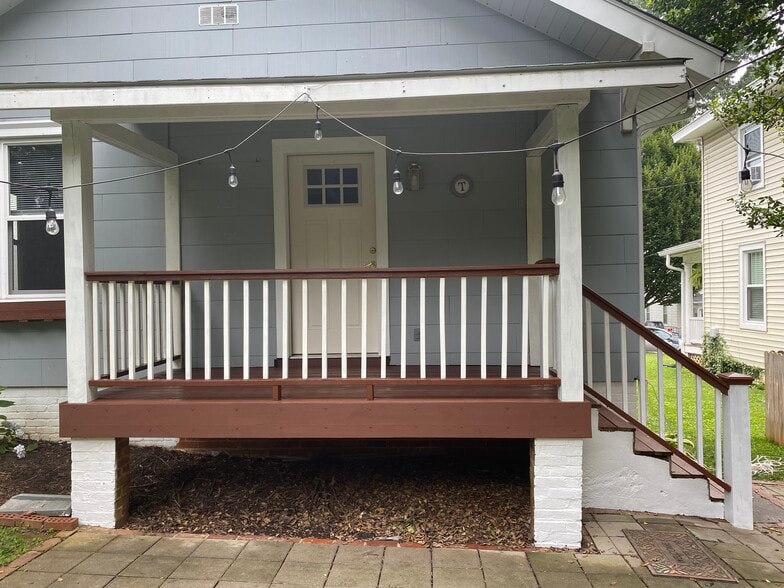 Covered back porch and paved patio area in back - 1505 Russell St
