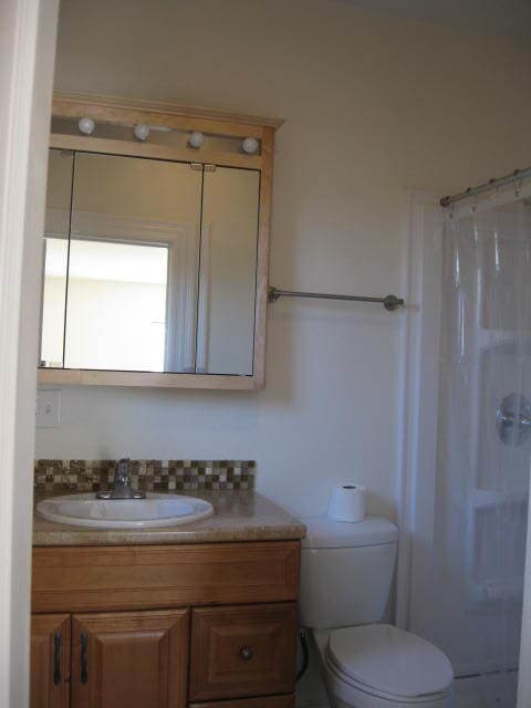 Bathroom. There is a window on the wall next to the vanity. - 1217 W 15th St