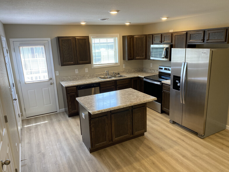 fully appointed kitchen with access to back balcony porch from kitchen - Pleasant View Apartments on Carroll Creek