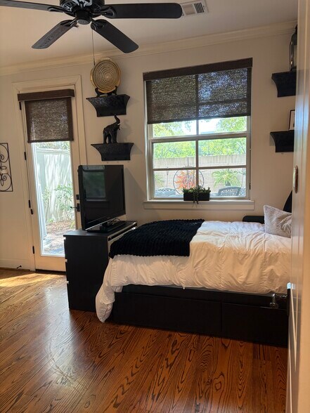 Private bedroom with full-size bed, smart tv and private backyard door exit. - 15927 Morgan St